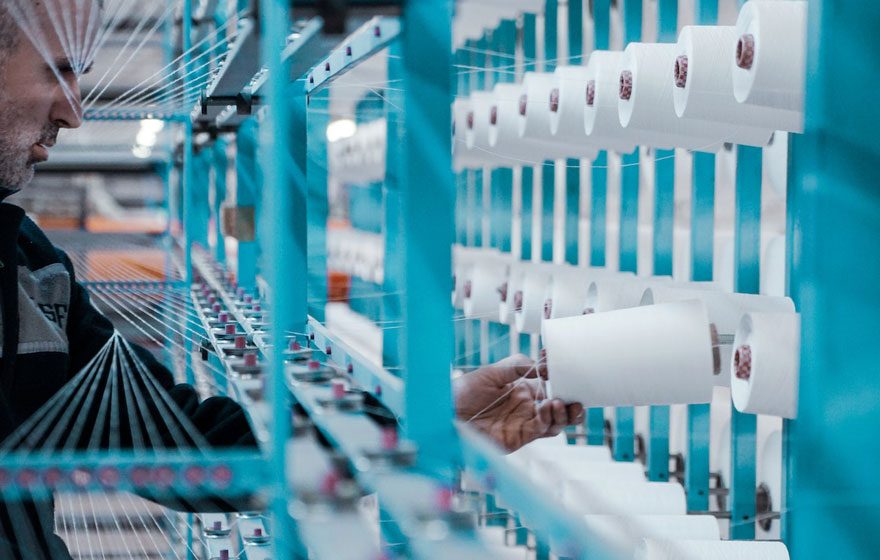 man working on textile machine